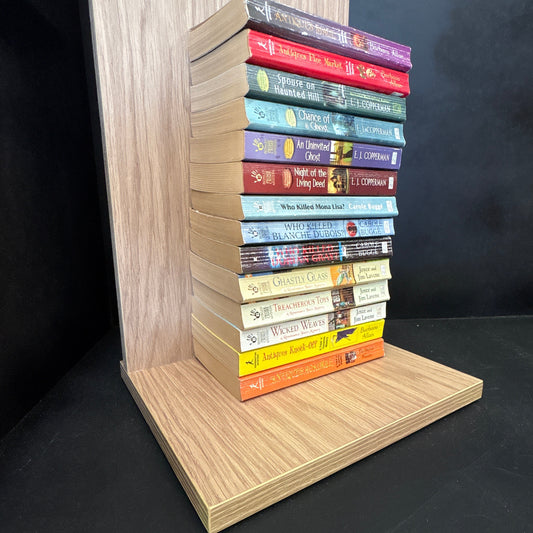 Wooden bookshelf with books of various colors on a black background